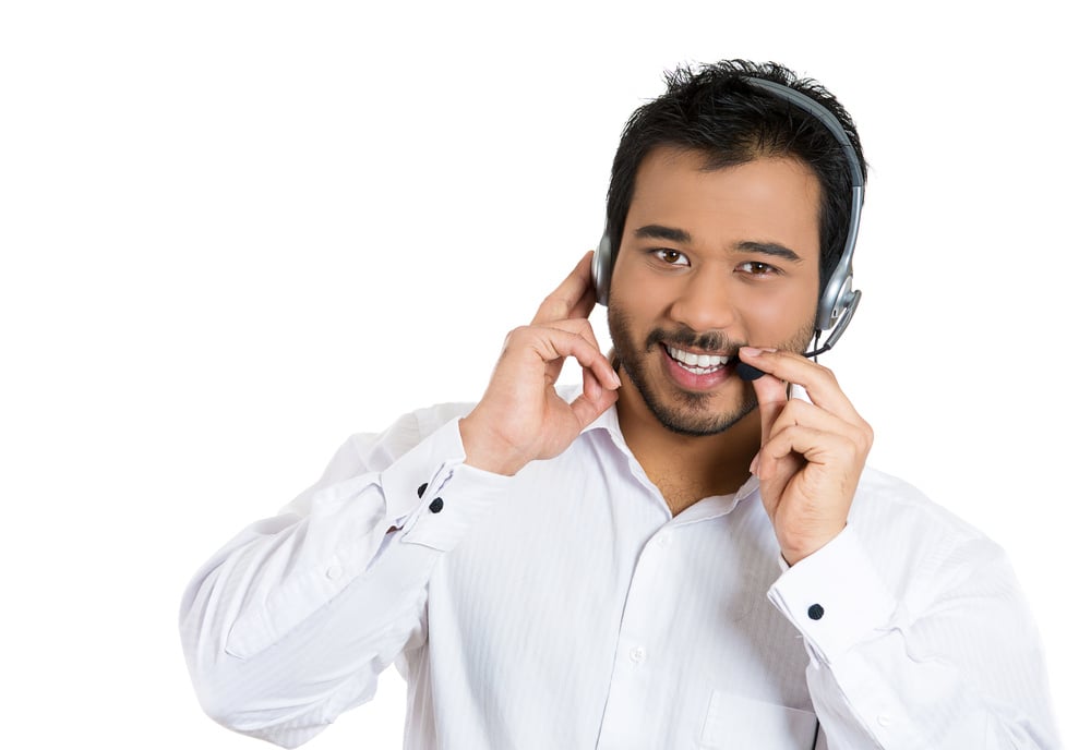 Closeup portrait of male customer service representative or call centre worker or operator or support staff speaking with head set, isolated on white background