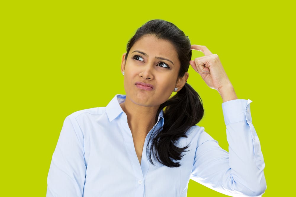 Closeup portrait, beautiful, pretty young woman thinking daydreaming trying to remember something, scratching head looking upwards, isolated green background. Human facial expressions signs symbols