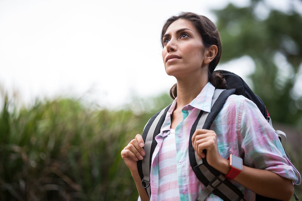 Woman hiking through a forest in the countryside